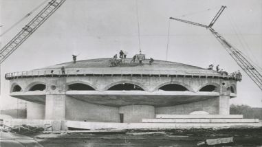 Dome under construction, construction cranes lifting concrete onto roof. Photo Credit: October 1960 AP Wire photo. Collection of Eric M. O'Malley.)